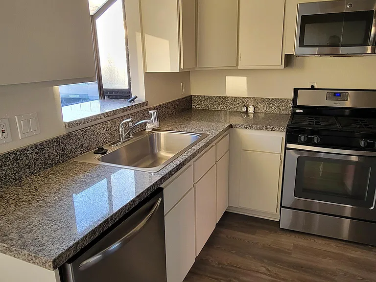 Kitchen: Granite Countertop, Dishwasher, Stainless Steel Sink w Garbage Disposal, Stove, Microwave & Lots of Cabinets