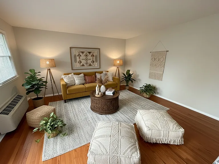 Digitally Staged- Living room at Duke View Apartments. Beautiful and spacious and ready for you to make your own with these Amazing hardwood floors.