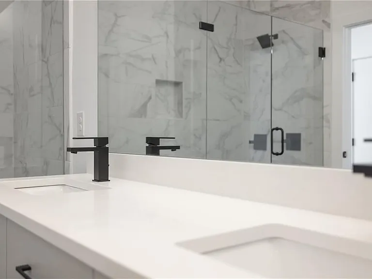 Main Bathroom (Note: Actual unit has light wooden floors and upgraded fixtures / appliances)
