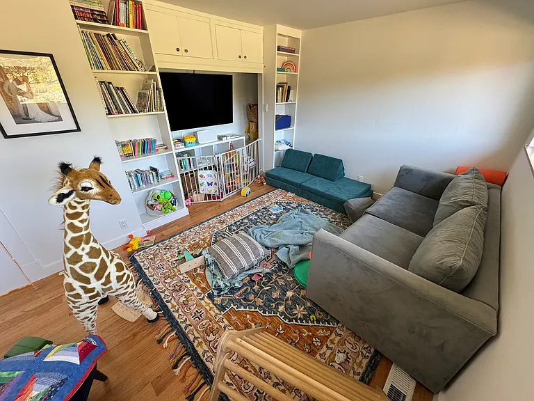 The larger, downstairs bedroom (or playroom)