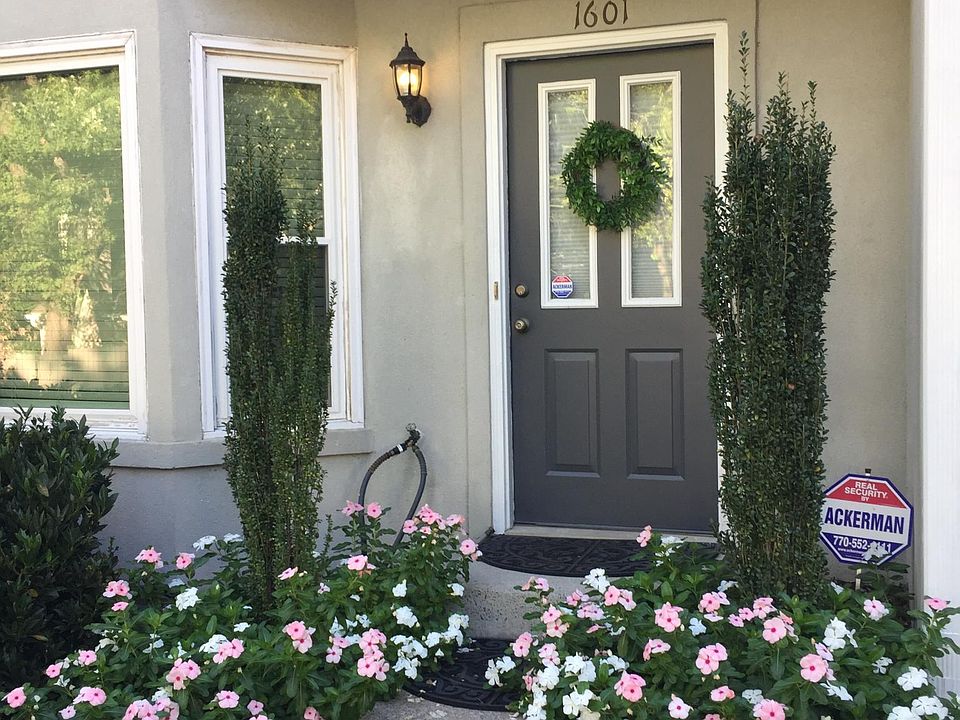 Front door directly adjacent to two reserved parking spaces in gated lot.