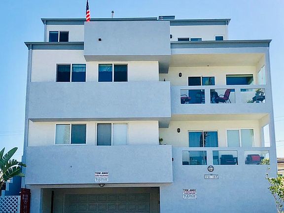North facing frontal view with garage, driveway, mailboxes and landscaping.