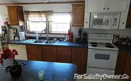 Kitchen
						:
						Custom Spice cabinet above the stove. Microwave above the stove. Dual sink.