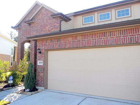Beautifully landscaped with a 2 car attached garage and cove
