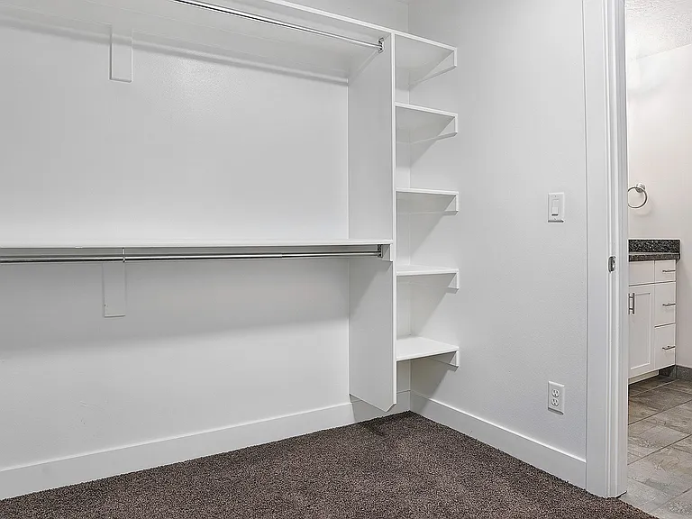 Walk-in closets provide generous storage with built-in shelving and organization.