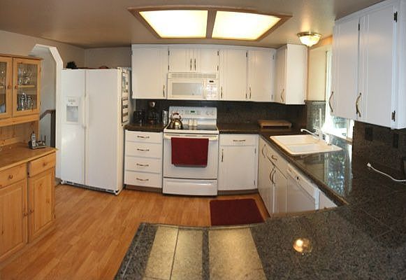 Granite counters, laminate wood floor, lots of storage and more!