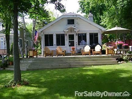 Lake Side of Home : Large wrap around deck.Deck has built in cedar seats by table.Great for parties!