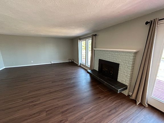 Large open living room with sound views and gas fireplace.