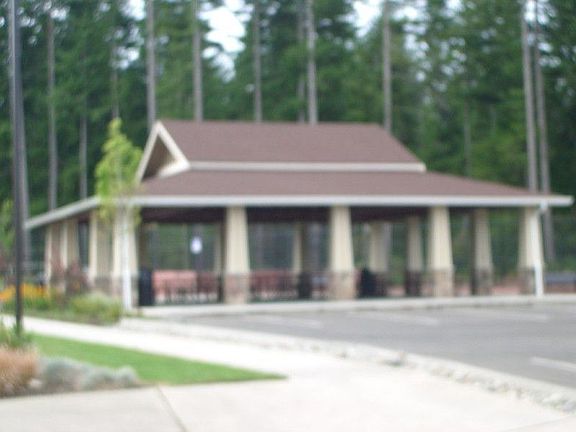Covered park pavillion next to tennis courts and trail to beach