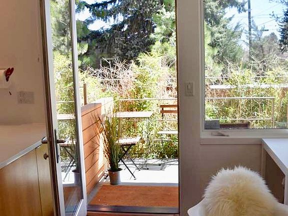 Front porch/patio has cafe table and chairs