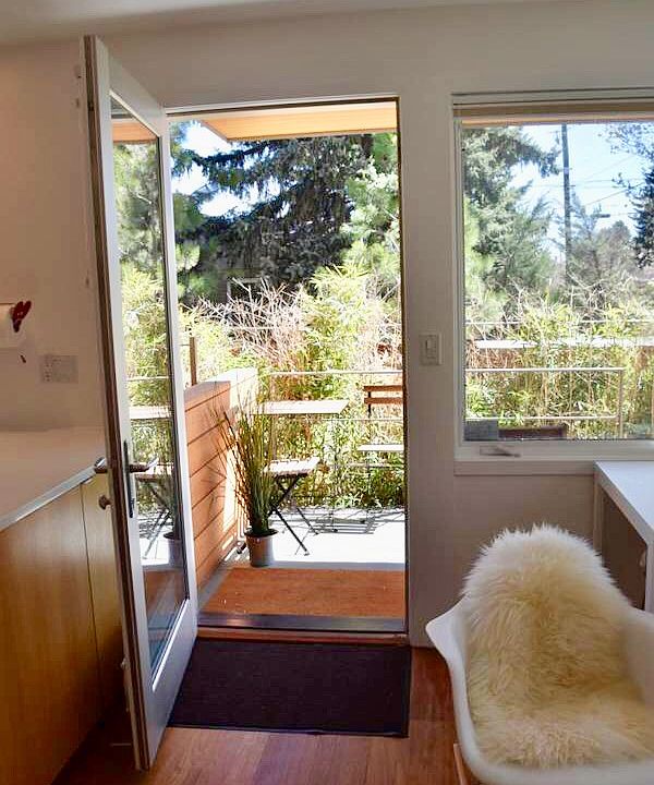 Front porch/patio has cafe table and chairs