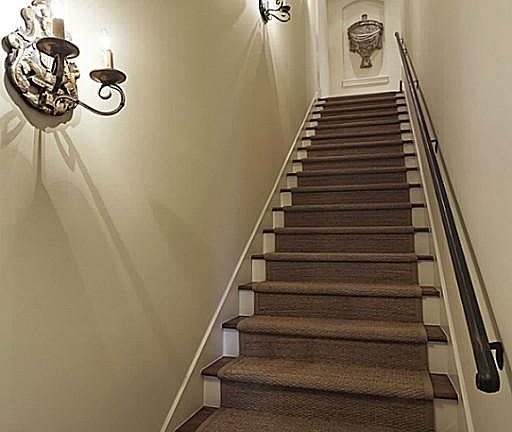 This pretty staircase leads to the third floor. Sisal carpet, rod iron railing and beautiful light f