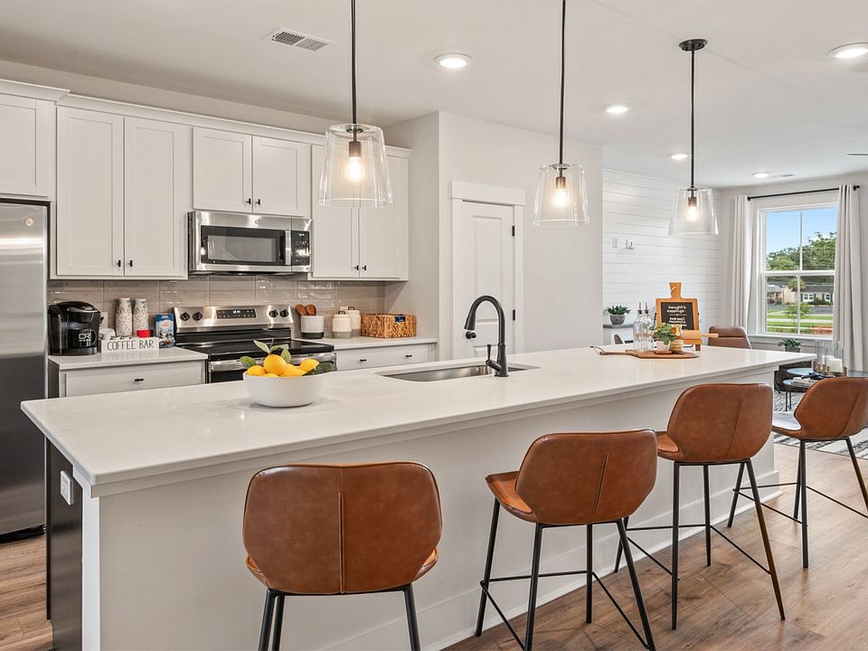 Kitchen island with seating, pendant lights, and open layout