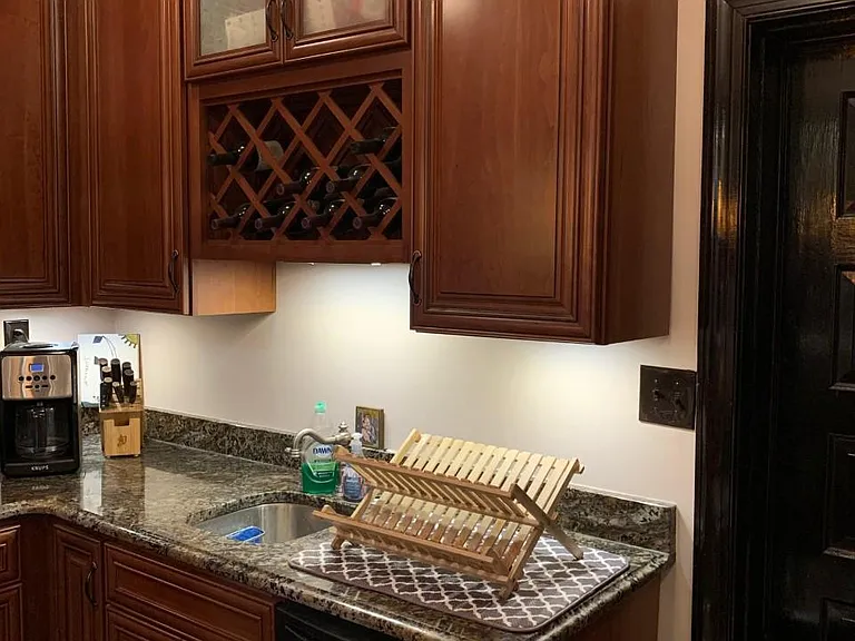 Lovely wine rack above sink w/garbage disposal. Stainless Steel dishwasher

Full size refrigerator-freezer and wine fridge. Stainless-steel microwave