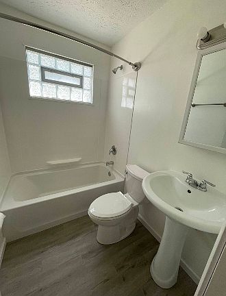 New tub, toilet, and flooring! Plus a permanent rounded shower rod.
