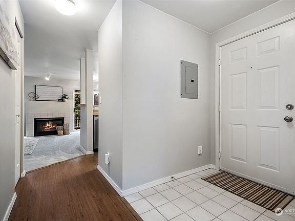 As you enter the unit there's a tiled entry and a laundry room to the right of this photo.>