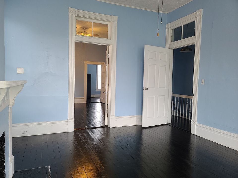 Sunny front room - can be living room or bedroom. Has a closet & decorative fireplace.