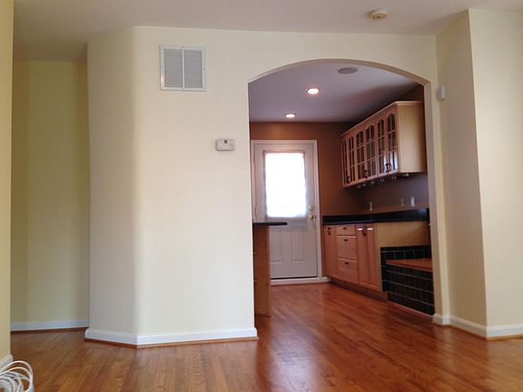 Kitchen arch with extra cabinetry, and door to back deck