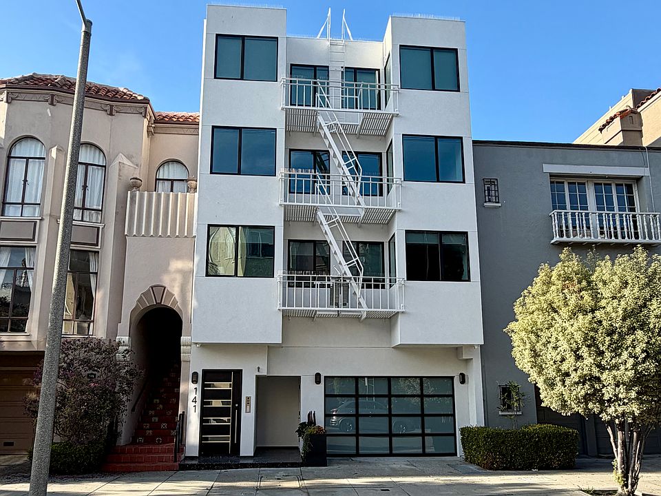 Exterior of building. Unit is on 2nd level above garage. Bedroom window is on the left.