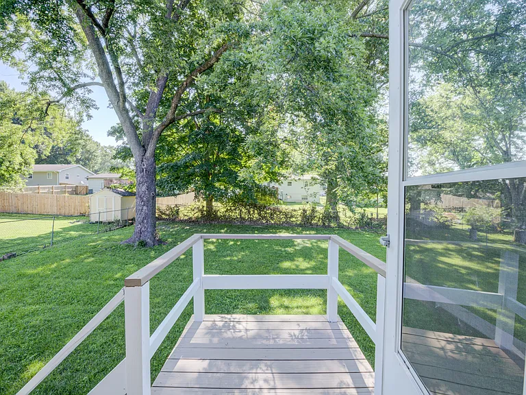 View from door next to the kitchen. Stairs go to the fenced rear yard.