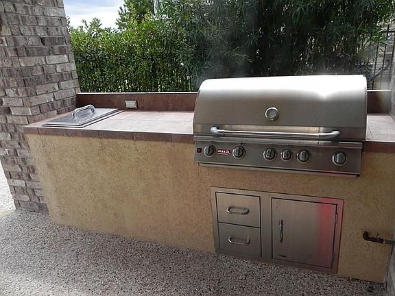 Outdoor kitchen awaits your culinary skills as your guests s