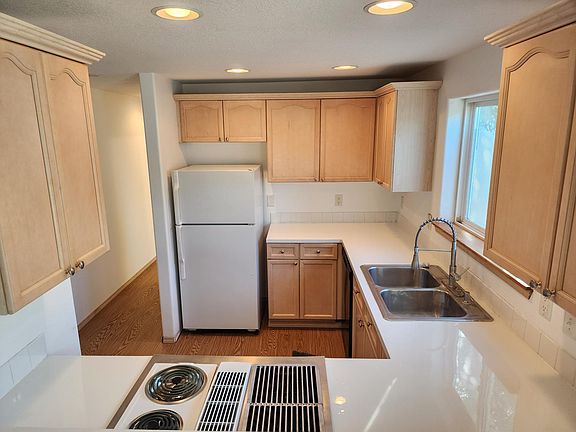 Kitchen, view from living room. New countertop and floors. Stove grill-top can be switched out for a second set of burners.