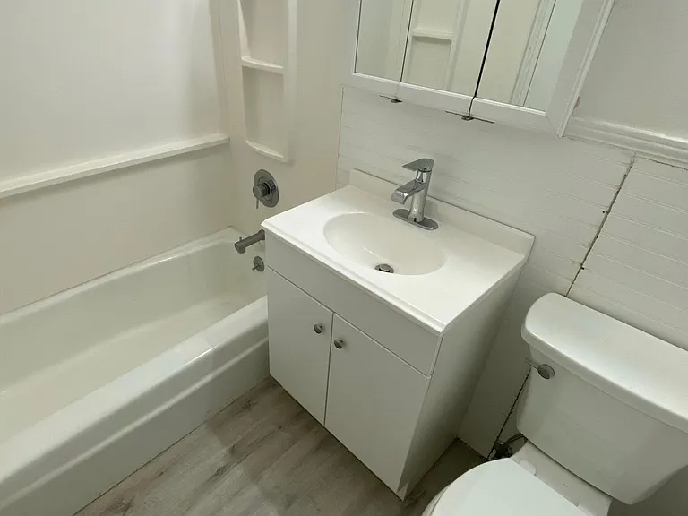 Newly renovated bathroom features new plumbing and new Moen shower, Moen faucet, Kohler toilet, new vanity and custom flooring.