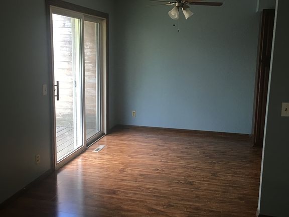 Dining area with fan and access to the deck