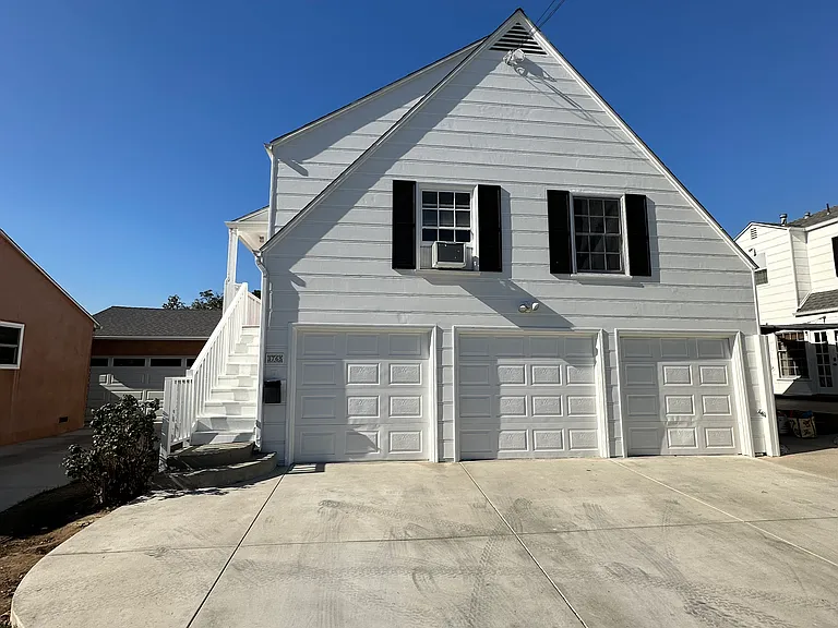 Carriage house from street view. Rental includes driveway parking closest to private stairway entrance.