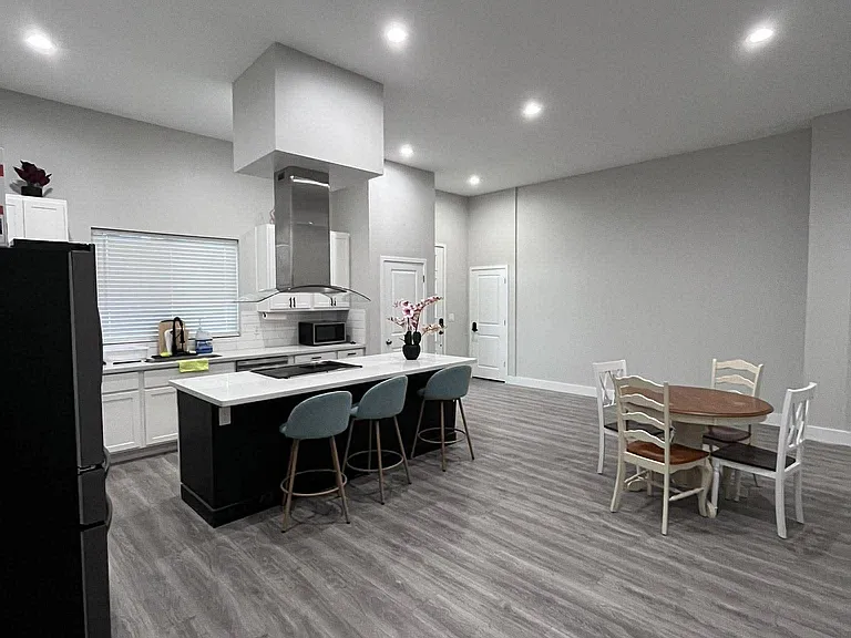 Open kitchen with a large island for seating, ample counter space, and an adjacent dining area for everyday meals.
