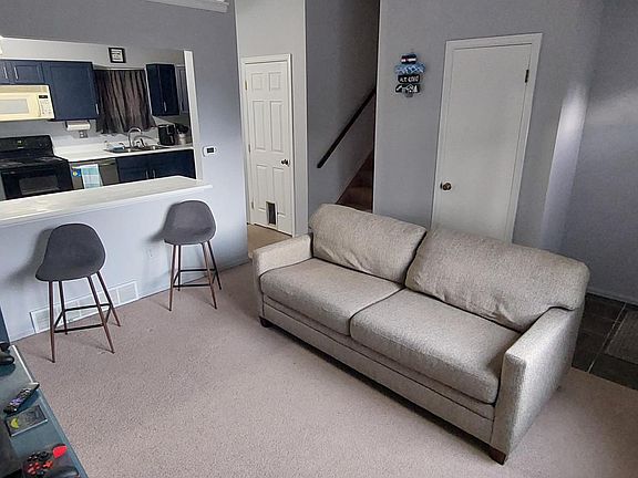 living room, view of kitchen and breakfast bar