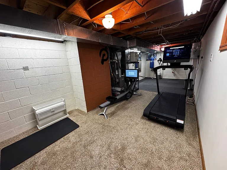 Basement gym with Hydro and Peloton Tread Plus treadmill. (from aft looking toward front of house).