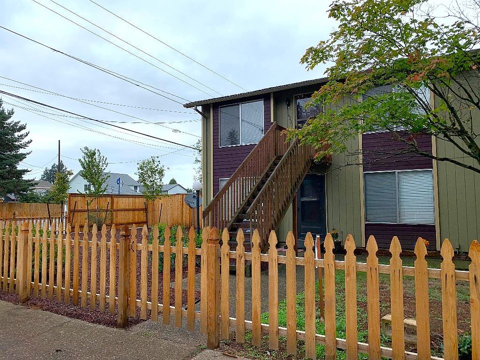 Street view of portion of tri-plex, gated on all sides.