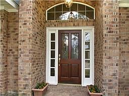 Charming entrance with brick columns and leaded glass door