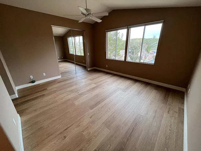 Spacious master bedroom with en-suite bath, walk in closet, and vaulted ceilings.