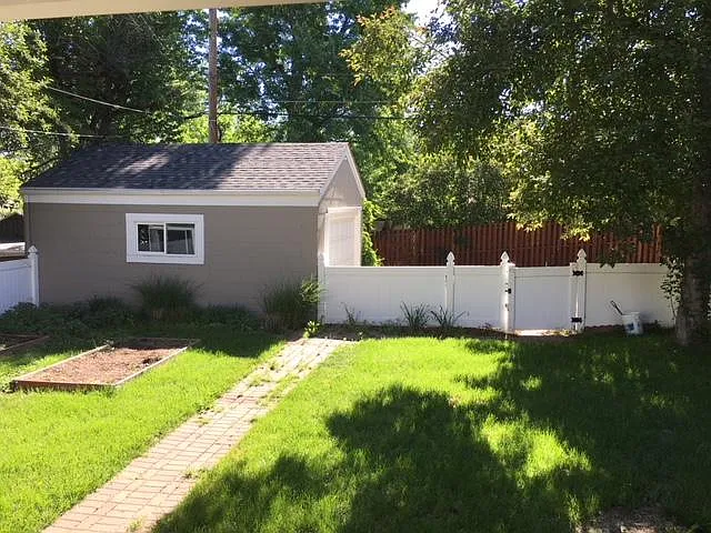 Oversized one car garage with work bench, vegetable gardens