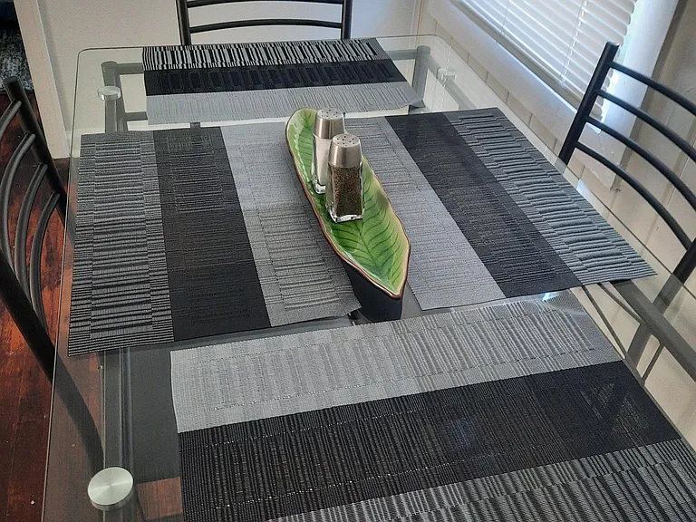Glass table fits four plus two can sit at the bar table.