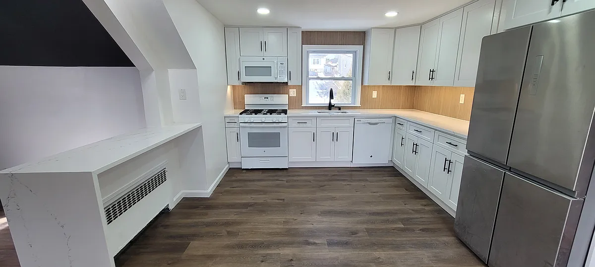 New white shaker cabinets, quartz countertops, tiled slat backsplash, black fixtures - 55 Corabelle Ave #2