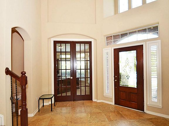 Beautiful entry with stained glass entry door, stained glass Study French doors, and large ceramic t