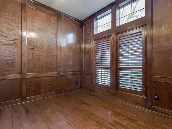Wood panel study offers tons of natural light and hardwood floors.