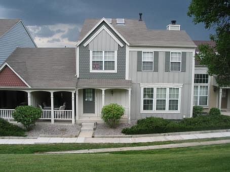 Front of townhome, and patio overlooking the HOA maintained lawn area