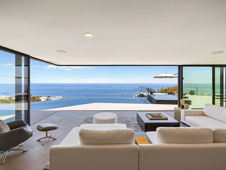The living room seamlessly blends indoor comfort with the awe-inspiring outdoor beauty.