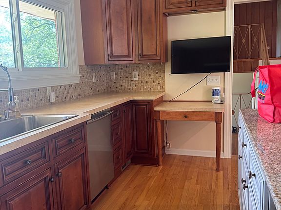 kitchen with a desk area to stay organized, dishwasher , stove, refrigerator, microwave and first floor washer and dryer