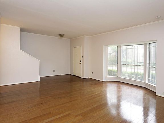 Shot of living/dining combination facing the front door. Beautifully redone hardwood floors.