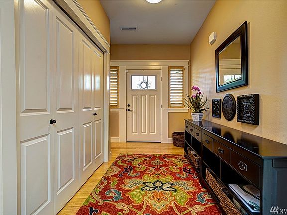 The front entrance sets the stage for the beautiful finish work you'll find throughout this wonderful home!  Notice the front accent light windows with shutters, the white panel doors with oil rubbed bronze finishes, and the colors that are completely in trend.  All this awaits your arrival!