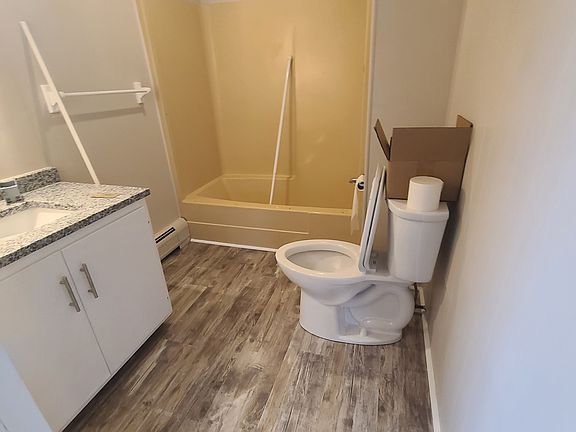 Bathroom with new granite sink, toilet and flooring
