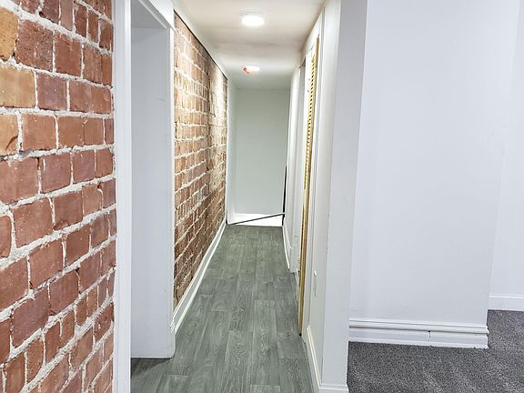 Apartment hallway with brick exposure.
