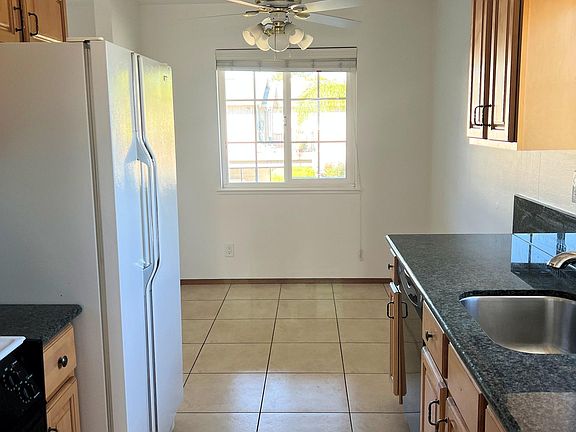 Maple cabinets. Porcelain tile floors. Stainless steel sink and faucet.