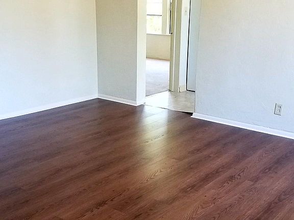 Living room looking into kitchen and bedroom