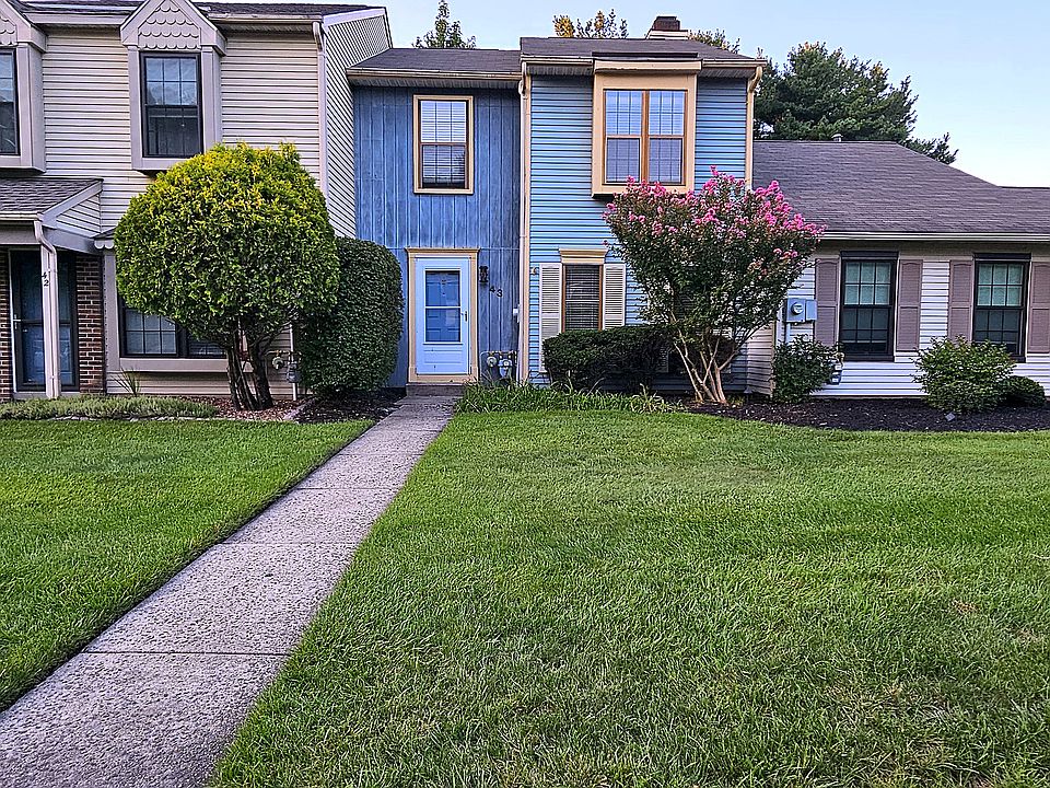 Welcome Home | Charming blue-sided townhome on a quiet Foxmoor cul-de-sac, with mature landscaping, a crepe myrtle in full bloom, and two dedicated parking spaces right at the door. |